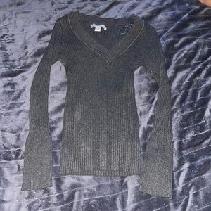 Gray sweater with v neckline.